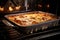 lasagna baking in the oven, with steam rising from the freshly baked noodles