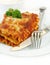 Lasagna with Fork and Knife on White