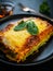 Lasagna with pork and spinach on black table