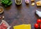 Lasagna, tomatoes, minced meat and other ingredients. Dark background. Italian cuisine