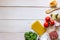 Lasagna, tomatoes, minced meat and other ingredients. White wooden background. Italian cuisine