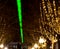 Laser beam over 1.5 km through the city center, sign of optimism in Corona Lockdown. With winterly decorated trees at the edge of