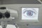 Laser eye surgery. Close-up workplace of an ophthalmologist surgeon, monitor with a graphic image of the eye, microskim for