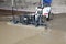 Laser screed machine leveling fresh poured concrete surface on a construction site