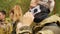 Laser tag game. Soldiers communicate among themselves. Men in camouflage with guns and playing airsoft. Close up shot.