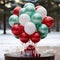 lassic red and green balloon display set against a snowy background.