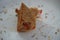 Last bite of a vegetable sandwich kept on plate. Side view shot of bread with tomato with the last bit