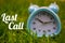 Last Call, Business Concept - text showing Last call with a clock on grass