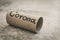 Last piece of toilet paper roll on the ground with hand drawn word corona