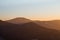 Last rays of the sun illuminating the mountainsides with orange light. Ostravice, Beskydy mountains, Ostrava