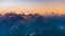 Last soft sunlight over rocky mountain peaks, ridges and valleys of the Alps at sunrise. Extreme terrain landscape at high altitud