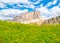 Lastoni de Formin, aka Ponta Lastoi de Formin. Giant mountain block with blooing meadow and summer sky, Dolomites, Italy