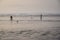 Late afternoon at beach, two people on the shoreline, Ocean Shores, Washington State, USA