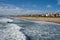 Late afternoon cityscape view of Manhattan Beach California, as seen from the pier, as waves from the Pacific Ocean roll in