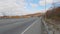 Late autumn. Country road going into the distance.