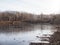 Late autumn. The first ice on the forest lake. The hummocks are covered with a thin layer of snow, the ice is very thin