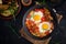 Late breakfast - fried eggs with vegetables. Shakshuka.