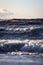 Late evening view of seaside waves near lighthouse