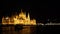 During the late hours the panoramic facade of the Hungarian Parliament in Budapest. The building is all lit.