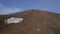 Late-season snow field in rocky barren terrain near summit of Asahidake