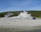 Late Spring in Yellowstone National Park: Castle Geyser Erupts as Tortoise Shell Spring Splashes in Upper Geyser Basin