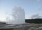 Late Spring in Yellowstone National Park: Old Faithful Geyser Eruption at Dusk in the Upper Geyser Basin