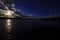 Late sun peeks through clouds over flooded farm field