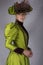 Late Victorian woman in green silk ensemble