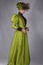 Late Victorian woman in green silk ensemble