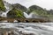 Latefoss twin waterfalls streams under the stone bridge archs, Odda, Hordaland county, Norway