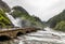 Latefoss waterfalls streams under the stone bridge archs, Odda, Hordaland county, Norway