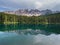 Latemar mount and woods reflected in Karersee lake, Dolomites, Italy