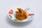 Lateral Hero shot of chicken curry with pasta noodles in a plate with minimal white background with 60 degree angle from