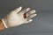 Latex glove hand tear, on gray background