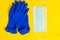 Latex gloves and medical face mask on a yellow background. Preventive protection against coronavirus