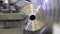 The lathe produces the metal part at the factory. Processing of the workpiece on a lathe. Working metal lathe. Heavy