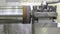 The lathe produces the metal part at the factory. Working metal lathe. Close up