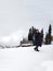 Latin adult woman with black jacket and gray backpack hiking in the snowy mountain very happy, free, full, positive, enjoys life a