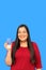 Latin adult woman shows a glass with drinking water that she drinks to stay hydrated in the heat wave