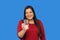 Latin adult woman shows a glass with drinking water that she drinks to stay hydrated in the heat wave