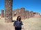 Latin adult woman tourist with sunglasses and hat knows the archaeological zone La Quemada in Zacatecas Mexico in a desert area of