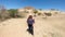 Latin adult woman tourist with sunglasses and hat knows the archaeological zone La Quemada in Zacatecas Mexico in a desert area of