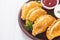 Latin American baked beef empanadas with sauce