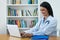 Latin american female doctor answering questions of patients online