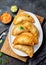 Latin American fried empanadas with tomato and avocado sauces. Top view