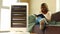 latin american woman with blanket reading a book in cold room with heater