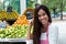 Latin american woman selling fruits at farmers market