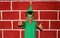 Latin child happy and excited for the arrival of December and celebrating Christmas shows his enthusiasm with hat and green Christ