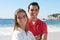 Latin couple at beach looking at camera