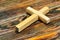 Latin cross on wooden background. Cross religious attribute of a geometric figure. In many beliefs carries sacral meaning - is